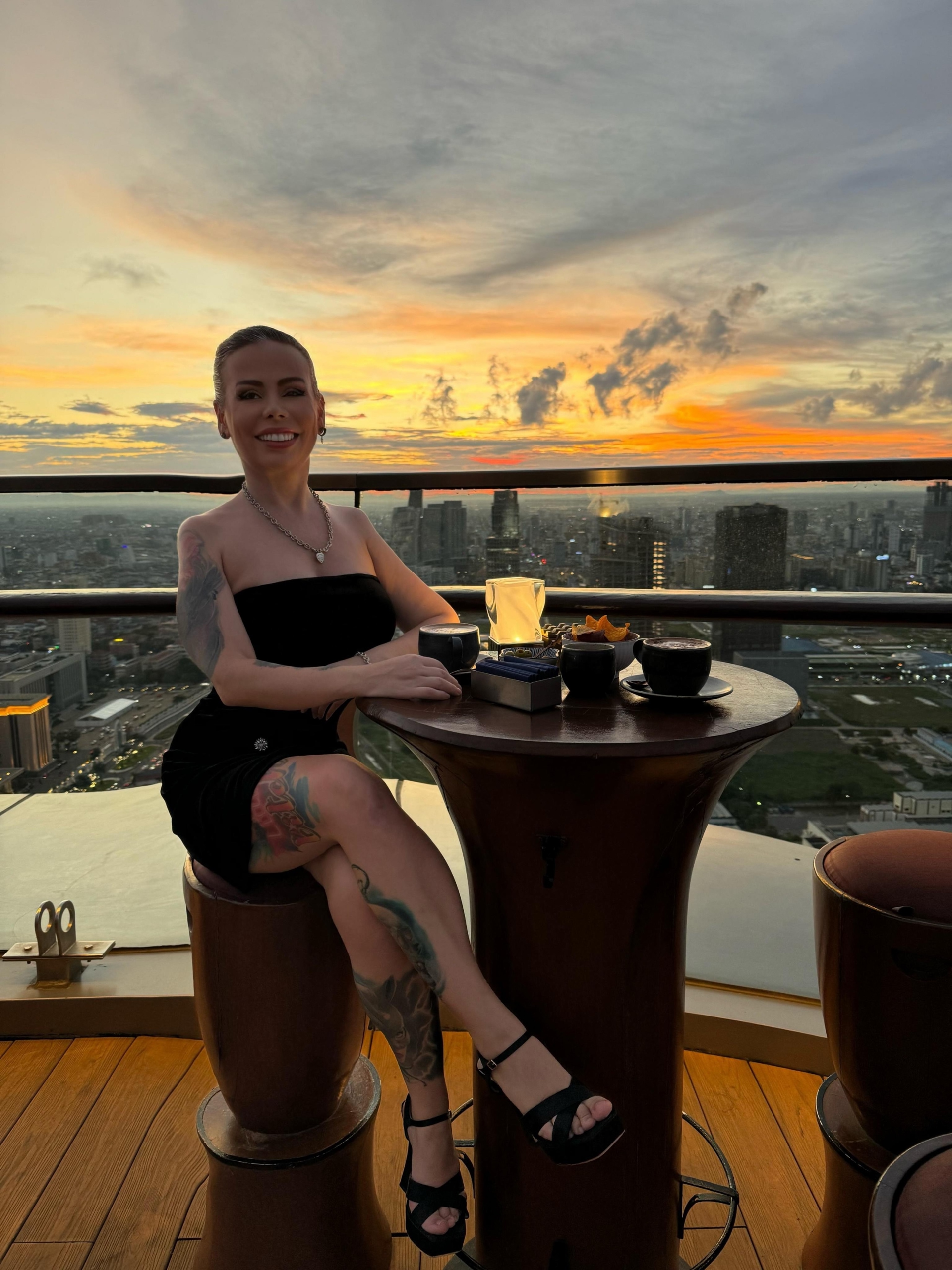 Maria Dyukova (Mariangel777) enjoying a sunset view from a rooftop restaurant